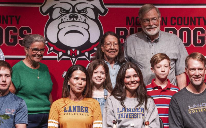 Backed up by supportive family members, Morgan County senior Camryn Scherer (center, grey shirt), is enthusiastic about continuing her scholastic and athletic careers at Lander University in South Carolina. SKYLA MORRIS/Staff