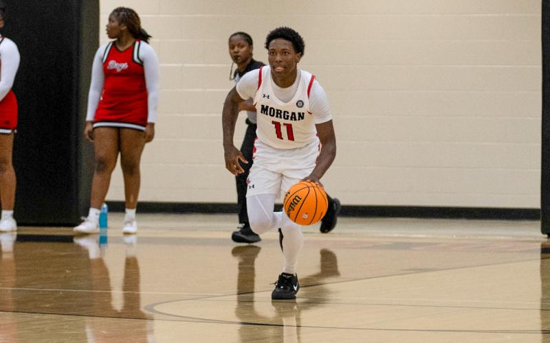 Morgan County senior Zeki Locus (11) pushes the ball up the floor in transition against Tattnall County on Feb. 28. SKYLA MORRIS/Staff