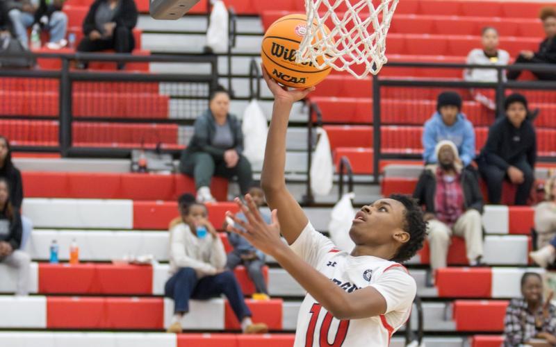 Morgan County sophomore Dreylon Brown (10) goes up for a layup in the Dogs' dominant win over Coahulla Creek. SKLYA MORRIS/Staff