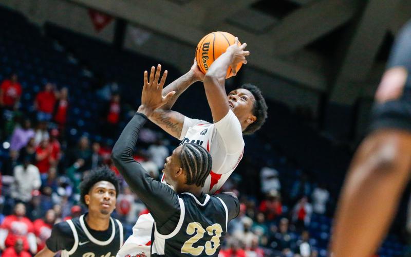 Morgan County senior point guard Zeki Locus goes up for a layup over a Butler defender. LANCE McCURLEY/Staff
