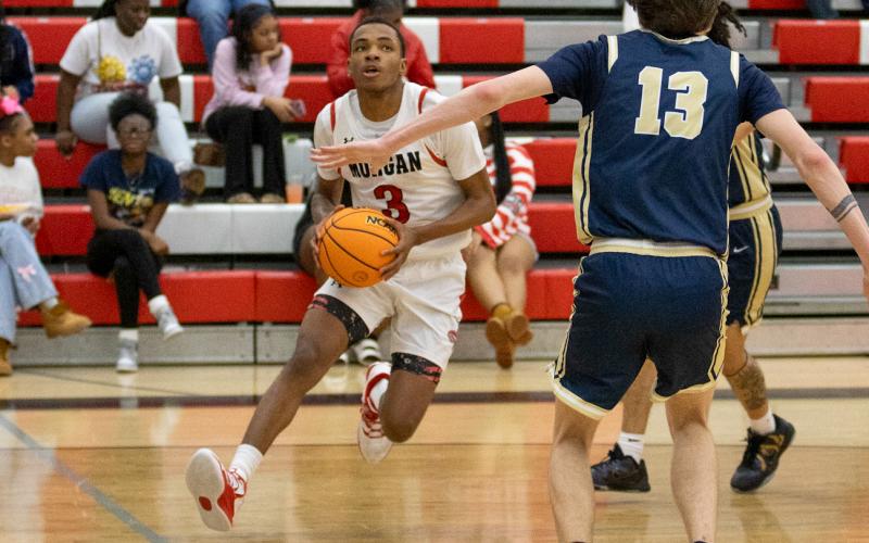 Morgan County junior SJ Odoms (3) drives the ball inside the paint. SKYLA MORRIS/Staff