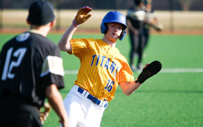 Evan Burton slides into third base safely during a game against Greene County on March 24. LANCE McCURLEY/Staff