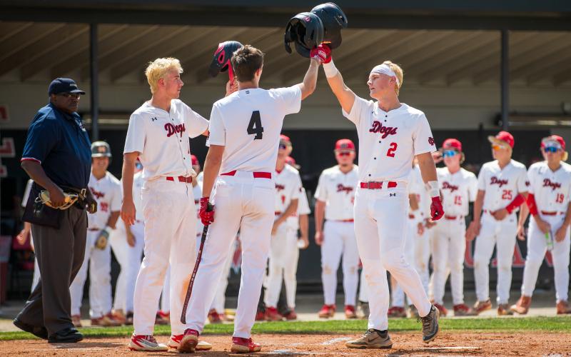 Morgan County High School's Hudson Reed (2) and Davis Strickland (4) celebrate after rounding the bases. SKYLA MORRIS/Staff