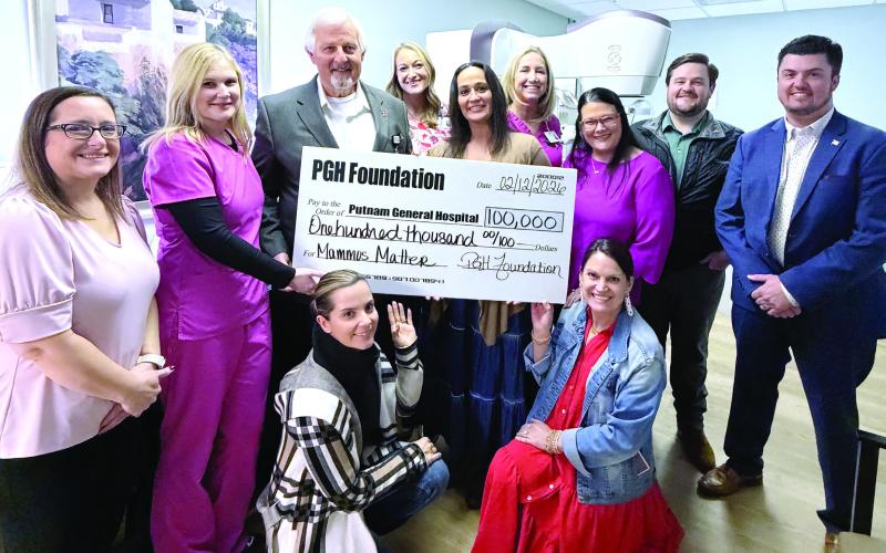 Putnam General Hospital leaders and staff pose earlier this month with a sizable contribution from the PGH Foundation on behalf of local donors. SKYLA MORRIS/Staff