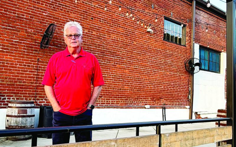Ken McCord in front of the former Oconee Brewing Company, now being launched as Barrel &amp; Rail. MAUREEN STRATTON/Staff