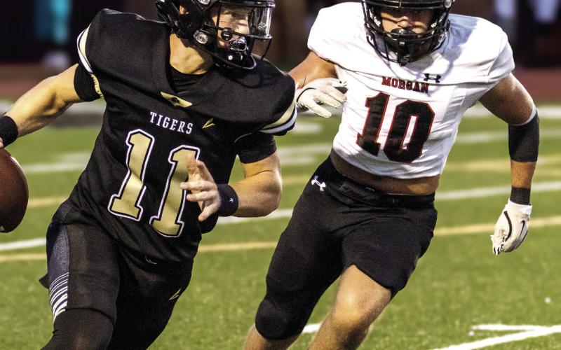 Brody Jenkins (10) chasing down Greene County quarterback Landon Garretson (11) during a game against the Tigers last season. SKYLA MORRIS/Staff