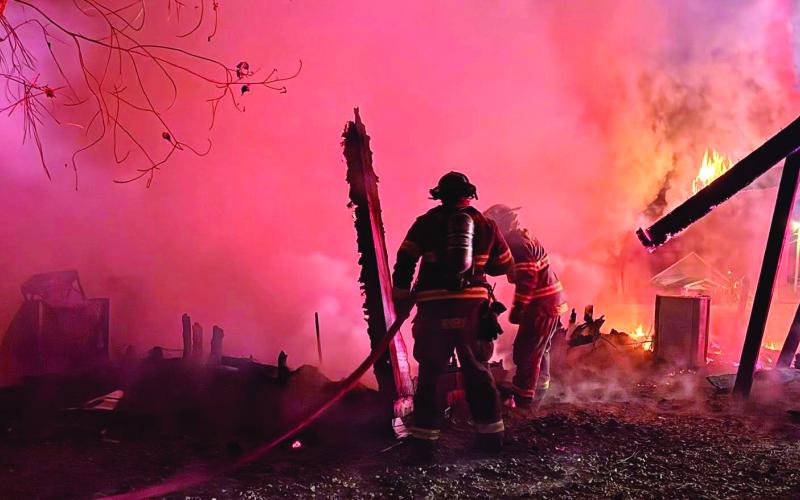 Putnam County Fire Department firefighters extinguish what was left of a fire that burned this detached garage to the ground last week. CONTRIBUTED