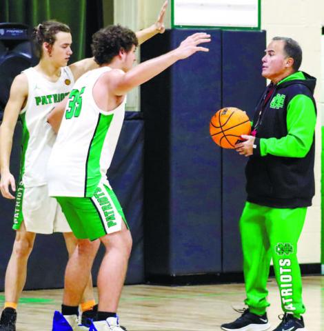 Nat Greene boys' basketball head coach Kevin Furtado instructs a few of his players through defensive drills during a practice last week. LANCE MCCURLEY/Staff