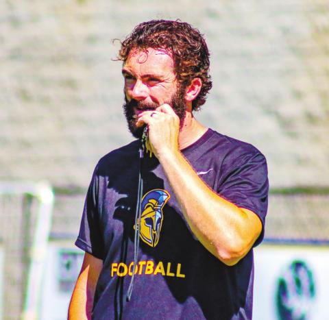 Stewart coaching up the Titans during a drill at Monday’s practice. LANCE McCURLEY/Staff