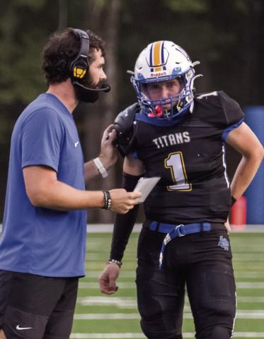 LOA head coach Patrick Stewart talks with quarterback Jake McDonald during a scrimmage against Social Circle on Aug. 8. SKYLA MORRIS/Staff