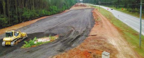 Georgia Dept. of Transportation contractor workers are making preparations to complete the US Hwy. 441 widening project in Putnam County. MARK ENGEL/Staff