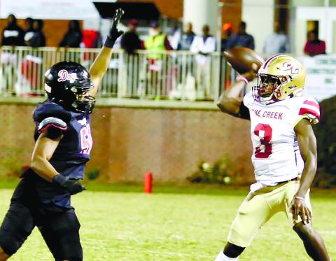 Morgan County defensive lineman Jamel Cox tries to bat down a pass thrown by Cross Creek quarterback Brandon Wallace (3). JIM TURNER/Contributed