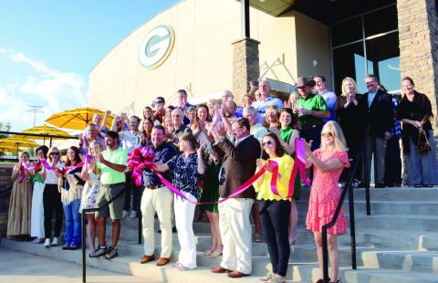 Head of Gatewood Schools Jeff Decker (center with bow) made the cut to officially open Gatewood’s new high school, though the building has been in use since school resumed early last month. IAN TOCHER/Staff