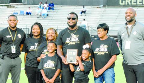 Principal Eddie Hood (far left) and athletic director Derrick Williams (far right) stand with Josh Nesbitt (center) and his family while being recognized at Greene County’s second annual Ring of Honor ceremony. BRENDAN KOERNER/Staff