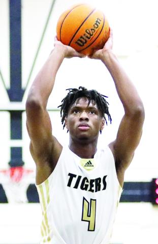 Greene County junior forward Laryous Burt (4) attempts a free throw. LANCE MCCURLEY/Staff