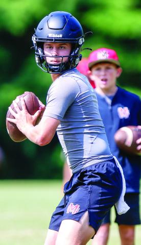 Junior quarterback Gunner Braswell prepares to throw a pass downfield during a 7-on-7 competition at UGA in June. LANCE McCURLEY/Staff