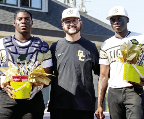 Greene County head coach Brad Evans (center) poses for a phot with seniors KD Andrews (left) and Jamarion Hill (right) before the team’s final regular season game against Hephzibah on Friday, April 18. LANCE McCURLEY/Staff
