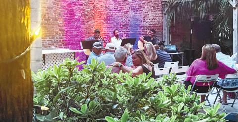 Guests enjoy acoustic music in the garden at Lake &amp; Local. CONTRIBUTED