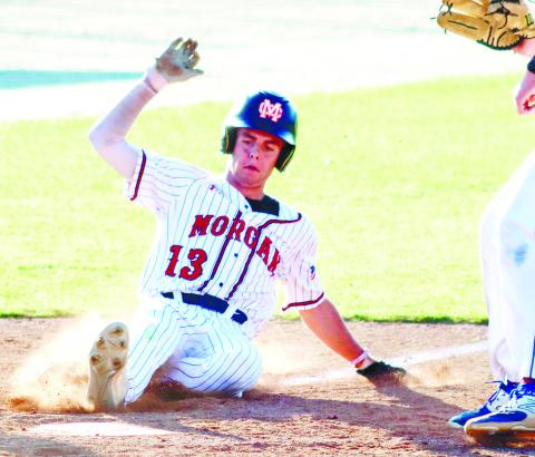 Morgan County junior Zach Moore (13) slides into home plate as the Bulldogs took a 3-2 lead over Columbus in game three on Monday. LANCE MCCURLEY/Staff