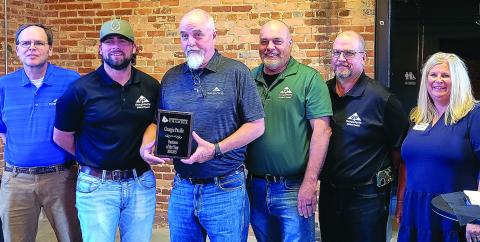 L-R: Georgia Pacific Madison-Plywood employees stand alongside Madison-Morgan Chamber of Commerce President, Shey Daniels, and accept the 2024-2025 Business of the Year award. SKYLA MORRIS/Staff