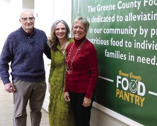 L-R: Steve Ruzika, Nancy DiSpirito, and Becky Smith, GCFP board members, standing in front of the Pantry’s mission statement. CONTRIBUTED