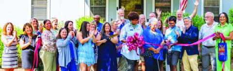 Employees and supporters of Seniors Helping Seniors Mid-South Georgia cheer as the ribbon is cut late last Tuesday to officially recognize the opening of the unique, new facility in Putnam County. CONTRIBUTED