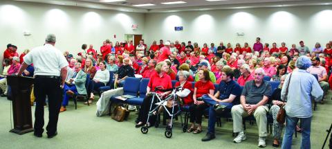 Putnam County Fire Chief Thomas McClain stands beside the podium after he delivered the news that up to 40 citizens attending a Planning &amp; Zoning meeting had to wait outside the large room at the county’s administration building. IAN TOCHER/Staff
