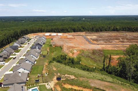 Ground was broken on the third phase of Traditions at Carey Station Saturday as the development grows.