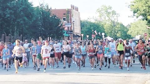 The 138 runners of the Dairy Festival 5K take off at the starting line. LYNN HOBBS/Staff