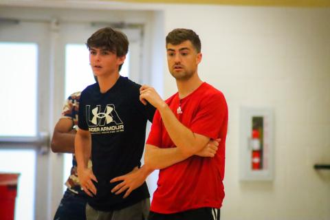 Anderson (right) watches a pick-up game during an open gym held at Morgan County High School on Tuesday night. LANCE McCURLEY/Staff