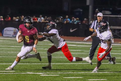Gavin Hall (6) scrambles out of the pocket, evading Morgan County defensive back Jay Dorsey (1). LANCE McCURLEY/Staff