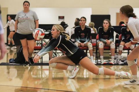 Makenzie Patzer (1) in a diving attempt trying to return a serve. LANCE MCCURLEY/Staff