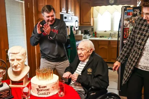 Georgia coach Kirby Smart applauds for Charley Trippi after Trippi blew out all the candles on his cake on his 100th birthday at his home in Athens. Trippi, one of the greatest players and athletes in Bulldogs history, died Wednesday. (Photo by Tony Walsh/UGA Athletics)