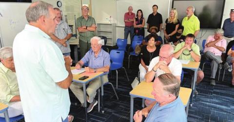 While the LOA Board was in a closed, executive session, the audience became an instant open, public chat session with members of the BOE about education issues facing the county. BOE Chairman Mike Lynch (seated, center) and Roger Fields (standing, left), representing the Lake Country Conservatives, a group actively seeking an end to the LOA lawsuit, join in the discussion. MARK ENGEL/Staff
