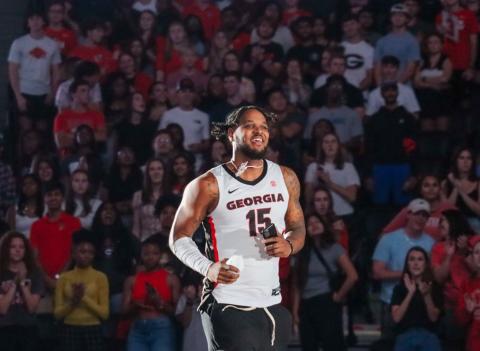 Ingram (15) runs out onto the court at Stegeman Coliseum last Friday. LANCE MCCURLEY/Staff