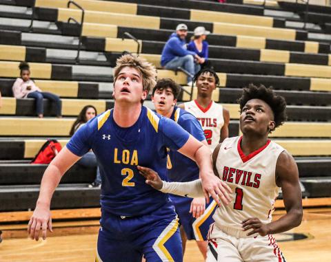 LOA senior Rhett Smith (2) boxing out Lincoln County's Semaj Jenkins (2) during a region tournament game last season. LANCE MCCURLEY/STAFF