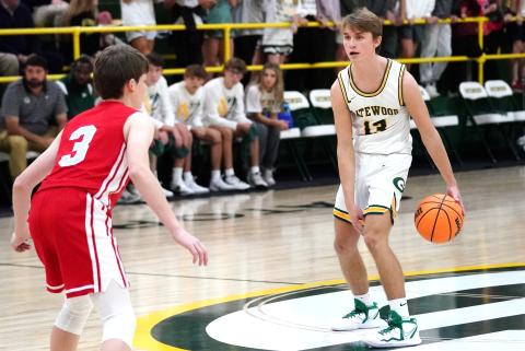 Kaden Keiser (13) holds the ball at the top of the key looking for a teammate to pass to. CONTRIBUTED