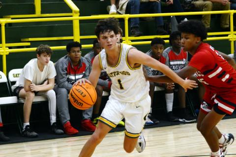 Gatewood senior Jackson Morris (1) drives the lane against a defender earlier this season. IAN TOCHER/Staff
