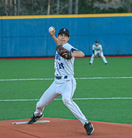 Garrett Payne (18) in the wind up while getting ready to deliver a pitch in a game last season. FILE PHOTO