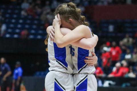 Two Lady Titans' players hug it out after losing to Clinch County on Wednesday at The Macon Centreplex. LANCE MCCURLEY/Staff