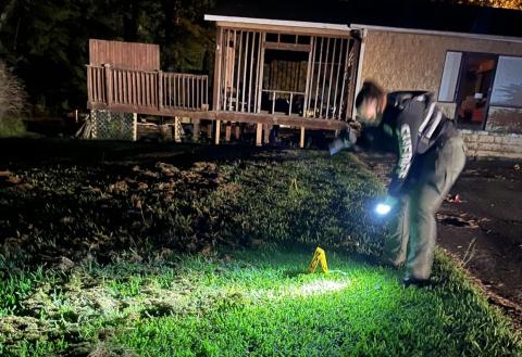 A member of the Morgan County County Sheriff's Department investigates the scene of the shooting following the party. CONTRIBUTED