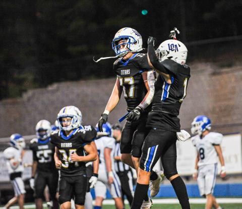 Ian Watson (17) and Logan Waldron (1) celebrate after a touchdown in a game against Towns County on Aug. 25. CHARLES JORDAN/Staff