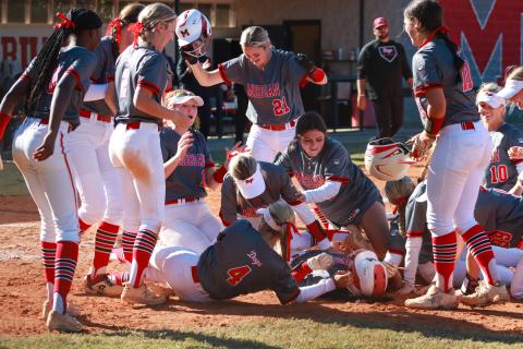 Morgan County players pile on Mallory Martin after defeating Peach County as she scored the game's final run, solidifying the Lady 'Dogs mercy rule win. LANCE MCCURLEY/Staff