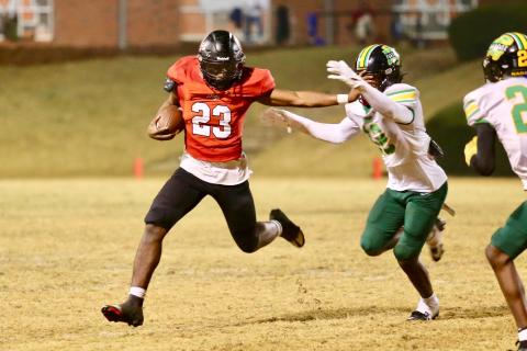Morgan County running back Christian Monfort (23) stiff arms a Monroe defender in last weeks win over the Golden Tornadoes. JIM TURNER/Contributed