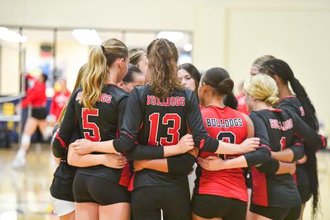 The Morgan County Spike Dogs huddle after winning a point against Prince Avenue earlier this week. (CHARLES JORDAN/Staff)