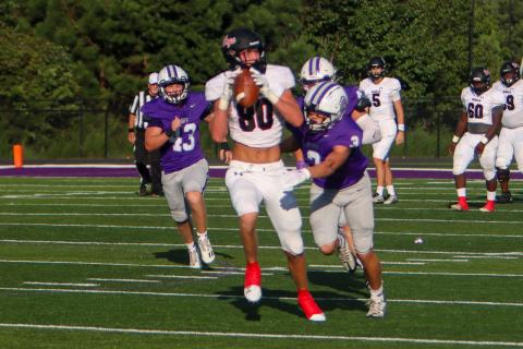 Morgan County tight end Drew Ainslie hauls in a pass over two Cherokee Bluff defenders during last week's scrimmage. (LANCE MCCURLEY/Staff)