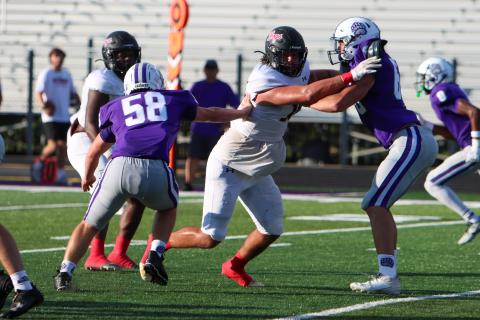 Morgan County football player Draco Frazzitta (18) blocks a Cherokee Bluff defender during last Thursday's scrimmage. Frazzitta recently committed to Navy. (LANCE MCCURLEY/Staff)