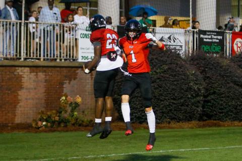 Morgan County running back Christian Monfort (23) and wide receiver Ty Tillery (1) celebrate in mid-air following a touchdown against Greene County last week. (LANCE MCCURLEY/Staff)
