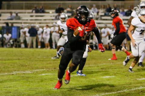 Morgan County running back Christian Monfort (23) rushes past defenders on his way to a first down. LANCE McCURLEY/Staff