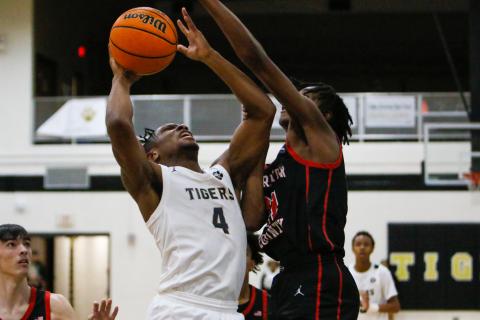 Greene County's Laryous Burt (4) attempts to go over a Charlton County defender during last week's first-round playoff matchup. LANCE MCCURLEY/Staff
